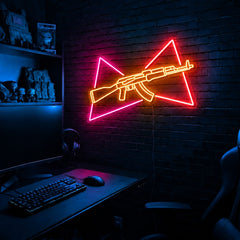 AK Split Triangles LED neon sign in the Solar Flare colorway, mounted on a brick wall in a gaming room