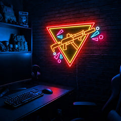 Rifle Inverted Triangle Confetti LED neon sign in the Solar Flare colorway, mounted on a brick wall in a gaming room