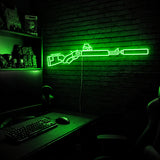Suppressed Lever Gun LED neon sign in Green on a clear backerboard in the TacArtCo gaming room