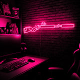 Suppressed Lever Gun LED neon sign in Pink on a clear backerboard in the TacArtCo gaming room