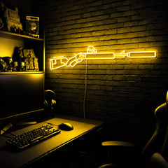 Suppressed Lever Gun LED neon sign in Yellow on a clear backerboard in the TacArtCo gaming room
