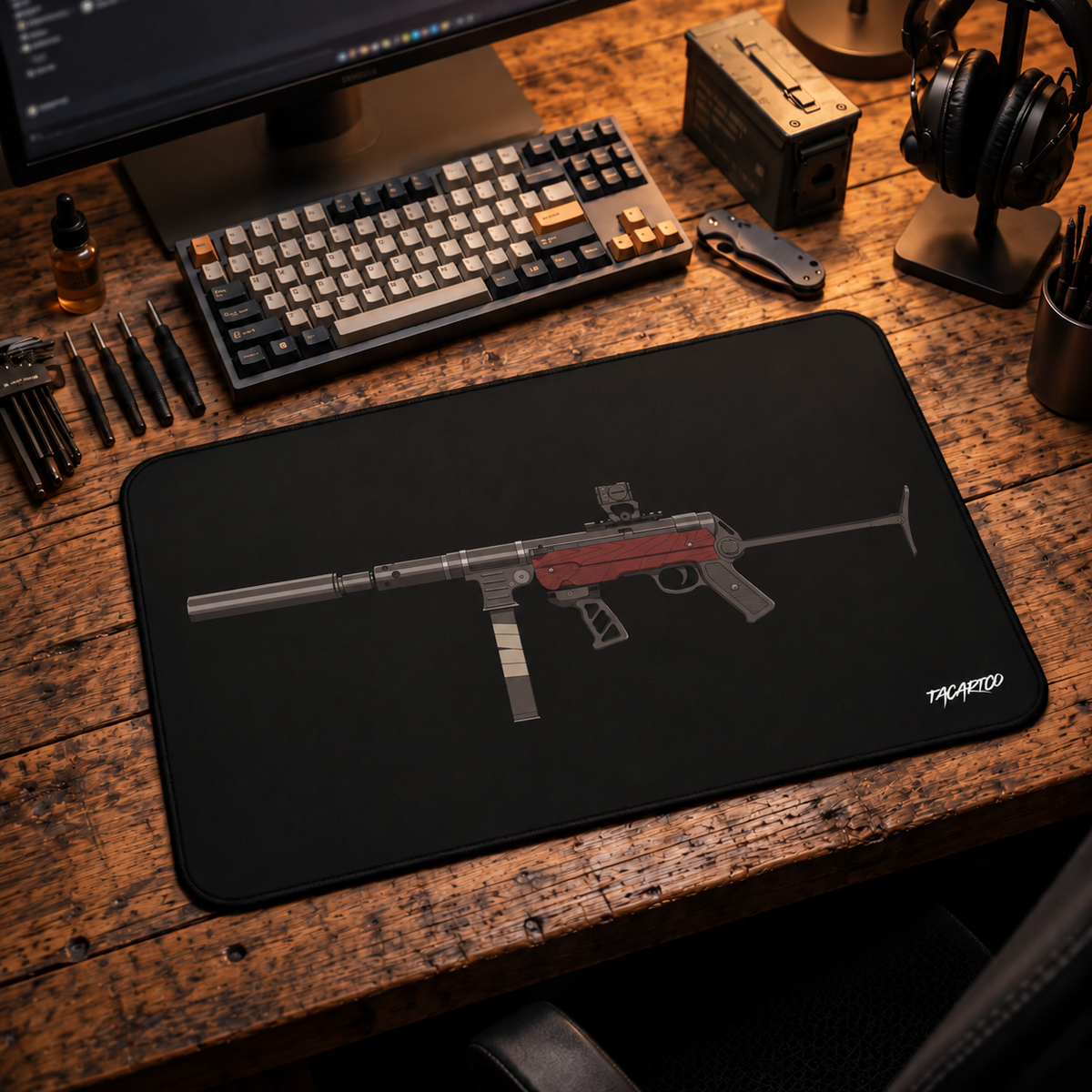 Tactical MP40 desk mat on a wood workbench with a keyboard and headphones